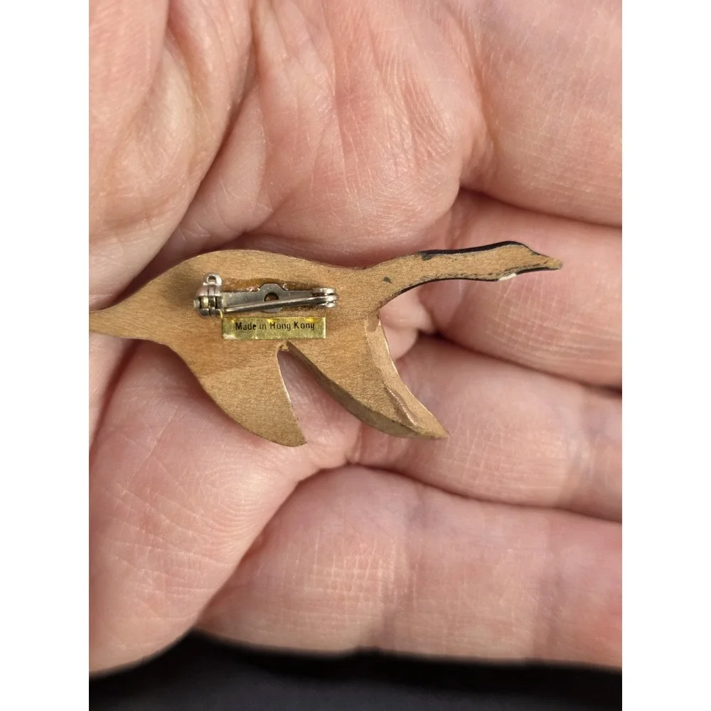 small, hand-carved and painted wooden Canada goose pin